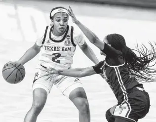  ?? Stephen Spillman / Associated Press ?? Guard Aaliyah Wilson (2), looking to drive around Troy’s Janiah Sandifer during the first half Monday in Austin, scored 12 points — one of four Texas A&M starters in double figures.