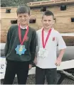  ??  ?? Kalen Lay and Mitchell Peggie with the medals they made.