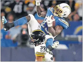 ?? [KELVIN KUO/THE ASSOCIATED PRESS] ?? Chargers running back Melvin Gordon, top, is tripped up by Steelers safety Minkah Fitzpatric­k during the Oct. 13 game in Carson, Calif.