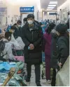  ?? QILAI SHEN/THE NEW YORK TIMES ?? Patients line a hallway Jan. 7 at a hospital in Shanghai. Beijing has greatly increased the official death toll from China’s current COVID-19 outbreak.