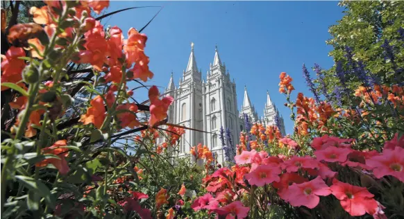  ?? AP FILE PHOTO ?? Flowers bloom in front of the Mormon Salt Lake Temple in Salt Lake City, Utah in 2015. The Church of Jesus Christ of Latter-day Saints has been criticized for posthumous­ly baptizing Holocaust victims and others.