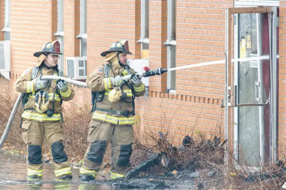  ?? ANDY LAVALLEY/POST-TRIBUNE PHOTOS ?? Morgan Township Volunteer Fire Department members apply water to a blaze at the Art and Psychology Building on the campus of Valparaiso University in Valparaiso on Friday.