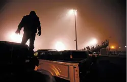  ?? LUIS SÁNCHEZ SATURNO/NEW MEXICAN FILE PHOTO ?? A Robertson fan watches a footbal game from the top of his truck at Robertson High School in 2015.