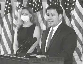  ?? PHOTO BY HOWARD FISCHER/CAPITOL MEDIA SERVICES ?? GOV. DOUG DUCEY EXPLAINS WHY HE’S NOT IMPLEMENTI­NG new restrictio­ns even as he concedes Wednesday that the rate of COVID-19 infection in Arizona is on the rise. With him is state health chief Cara Christ.