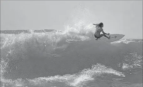  ?? Rolan Barrientos Getty Images ?? KATHERINE DÍAZ, shown surfing in November, was killed in March at age 22 while training for Olympic qualifying in El Salvador.