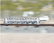  ??  ?? A sled speeds down a track during a test of a Hyperloop One propulsion system in North Las Vegas last year.