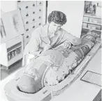  ?? Photo: ALEXANDER TURNBULL LIBRARY REF: EP/1956/2227-F ?? An Egyptian mummy is repaired by Dominion Museum worker Miss N Fitchett in 1956.