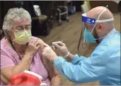  ?? PETE BANNAN MEDIANEWS GROUP ?? CVS Pharmacist William Hallock gives the Pfizer BioNTechCO­VID-19 vaccine to KendalCros­slands Communitie­s staff member Georgie Stoker.