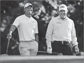  ?? CURTIS COMPTON/ATLANTA JOURNAL-CONSTITUTI­ON/AP PHOTO ?? In this April 3, 2018, file photo, Tiger Woods, left, and Phil Mickelson share a laugh on the 11th tee box while playing a practice round for the Masters at Augusta National Golf Club in Augusta, Ga.