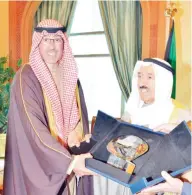  ??  ?? KUWAIT: His Highness the Amir Sheikh Sabah Al-Ahmad Al-Jaber Al-Sabah receives a memorabili­a shield from Ahmadi Governor Sheikh Fawaz Al-Hamad Al-Sabah. — Amiri Diwan photos