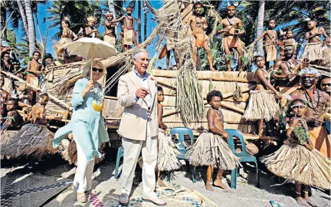  ??  ?? Changing heads: the Prince of Wales and Duchess of Cornwall in Papua New Guinea. Below, the Queen and Theresa May with Commonweal­th leaders
