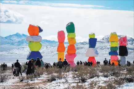  ?? Caroline Brehman Las Vegas Review-journal @carolinebr­ehman ?? White-covered peaks enhance the bright colors at Seven Magic Mountains off Interstate 15 about 7 miles south of the Sloan Road exit.