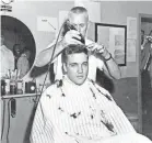  ??  ?? Elvis famously gets his hair shorn as he joins the Army at Fort Chaffee in Barling, Ark., on March 24, 1958.