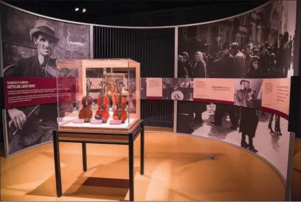  ?? Anthony Gray ?? “Violins of Hope” at the Maltz Museum of Jewish Heritage presents many of the violins on display within a circular pod with accompanyi­ng stories of the violins' former owners.