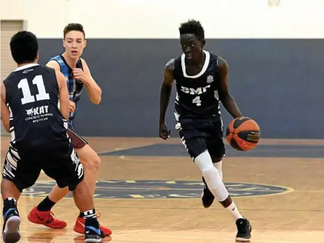  ?? Photos: Bev Lacey ?? IN THE LANE: St Mary’s College player Chol Mayham looks to drive to the basket during a Year 9/10 AAG Cup match against Highlands Christian College.