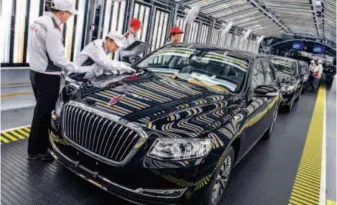  ??  ?? April 8, 2019: Workers on the Hongqi assembly line at China FAW Group Co., Ltd. in Changchun, Jilin Province. by Xu Chang/xinhua