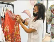  ??  ?? Store manager Gerijo Matyka at the new clothing and accessorie­s shop Johnny Was on Wednesday in Westport.