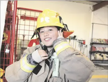  ?? MARCIE LANDEROS PHOTO ?? Holtville Fire Department volunteer Maggie Velasco puts on fire gear at the Holtville Fire Department, Nov. 10, in Holtville.