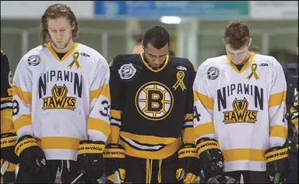  ?? CP PHOTO ?? Members of the Nipawin Hawks and Estevan Bruins observe a moment of silence prior to the opening game of the Saskatchew­an Junior Hockey League championsh­ip series Saturday in Nipawin, Sask.