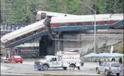  ?? REUTERS ?? The scene where an Amtrak passenger train derailed on a bridge over interstate highway I5 in Dupont, Washington.