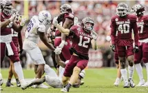  ?? Tim Warner/Getty Images ?? Texas A&M’s Sam Mathews (12) celebrates after a tackle during the fourth quarter against Abilene Christian on Saturday.