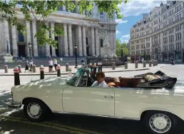  ??  ?? Enjoying a spin with her son Lorne around the City of London without traffic in his 1970 Mercedes parked outside St Paul’s Cathedral