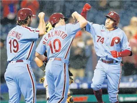  ?? YONG KIM/THE PHILADELPH­IA INQUIRER ?? Philadelph­ia Phillies pinch-hitter Ronald Torreyes celebrates his three-run home run with J.T. Realmuto and Matt Vierling against the Pittsburgh Pirates on Sept. 23 at Citizens Bank Park in Philadelph­ia.