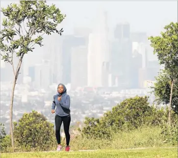  ?? David McNew Los Angeles Times ?? ONE BOND proposal would authorize nearly $4 billion in spending on water and parks improvemen­ts. Another would allocate $3.1 billion for parks. Above, a jogger at Kenneth Hahn State Recreation Area.