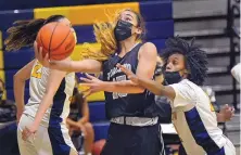  ?? CREDIT ?? Volcano Vista guard Jaelyn Bates goes up for a shot Wednesday night against Highland, with Deniece Ryan (right) defending for the Hornets. Bates finished with 23 points in the win.