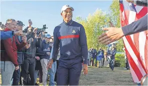  ?? IAN RUTHERFORD/USA TODAY SPORTS ?? Tiger Woods acknowledg­es the cheers during a Ryder Cup practice round Tuesday in France.