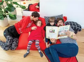  ?? ?? STRETCHING OUT: The family use giant cushions instead of a sofa