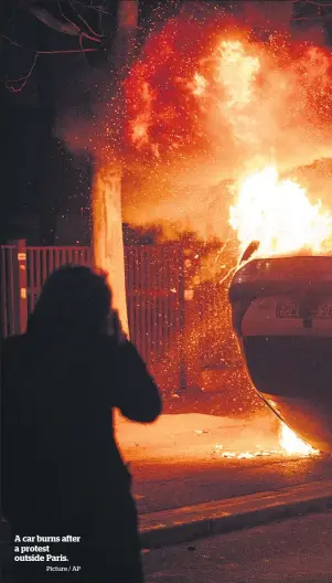  ?? Picture / AP ?? A car burns after a protest outside Paris.