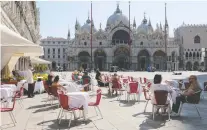  ?? MANUEL SILVESTRI/REUTERS ?? Tourists enjoy Gran Caffè Quadri at St. Mark’s Square in Venice on Sunday. Italy reopened its border this month.