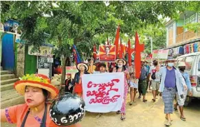  ?? — aFP ?? Not giving up: anti-junta protesters marching during a demonstrat­ion in hpakant, Kachin state.