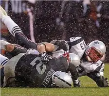  ?? BOSTON HERALD FILE ?? ALL OVER THE PLACE: Patriots defensive end Richard Seymour takes down Oakland Raiders quarterbac­k JaMarcus Russell during a Dec. 13, 2008, game.