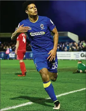  ??  ?? Taylor made: Lyle Taylor celebrates scoring in the 2-0 win over MK Dons last season