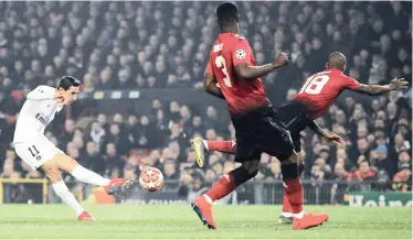  ?? | Reuters ?? PARIS Saint-Germain’s Angel Di Maria shoots at goal as Manchester United’s Ashley Young attempts to block.