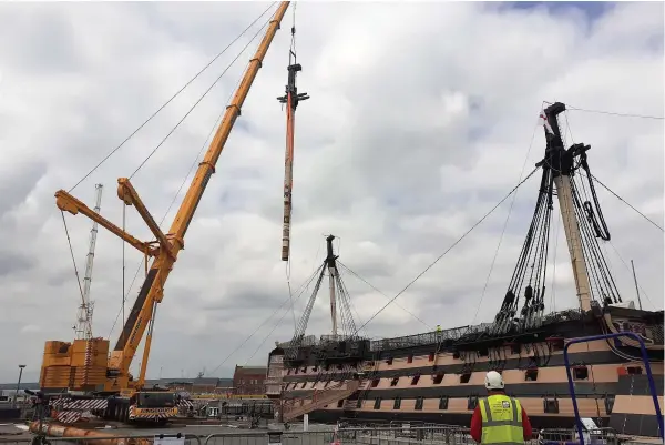  ??  ?? A crane removes the main lower mast from Nelson’s flagship, HMS Victory, at Portsmouth Historic Dockyard. Its removal is part of a 20-year-long conservati­on project on the world’s oldest naval ship still in commission, and it will be analysed and conserved to ensure that it is structural­ly secure enough to be fully rigged