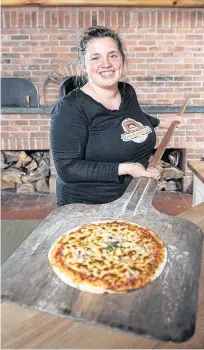  ?? SUBMITTED ?? Bonavista Social Club owner Katie Hayes with a pizza just out of the wood-fired oven.