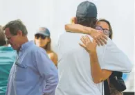  ?? Christian Monterrosa, The Associated Press ?? People hug each other while awaiting news of the dive boat fire Monday outside the Truth Aquatics office in Santa Barbara, Calif. At least eight died in the fire.