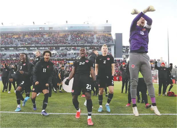  ?? CARLOS OSORIO / REUTERS ?? Canadian players celebrate on the pitch after defeating the United States 2-0 at Tim Hortons Field in Hamilton on Sunday to remain undefeated
and in first place in the CONCACAF qualifiers for this year’s World Cup in Qatar.