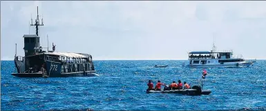  ?? PROVIDED TO CHINA DAILY ?? Chinese and Thai crews (clockwise from top) work on search and rescue on Sunday in the waters off Phuket, Thailand, near the site of Thursday’s deadly capsizing of two ships. ZHANG SHIBO / FOR CHINA DAILY Friends return survivor Huang Junxiong to his ward in Phuket on Sunday.QIN QING / XINHUA A member of the Rescue Team of Ram Union from Zhejiang province prepares to use sonar.