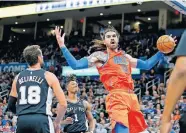  ??  ?? Steven Adams (12) dunks the ball beside San Antonio's Marco Belinelli (18) and Lonnie Walker IV (1) during the Thunder's 131-103 win on Feb. 23. [BRYAN TERRY/THE OKLAHOMAN]