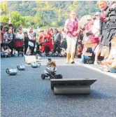  ??  ?? A big crowd gathered around the tea pot racers.