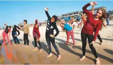  ?? AFP ?? Young Palestinia­n members of a swimming club participat­e in a group excercise on the beach during a training session in Beit Lahia in the Gaza Strip.
