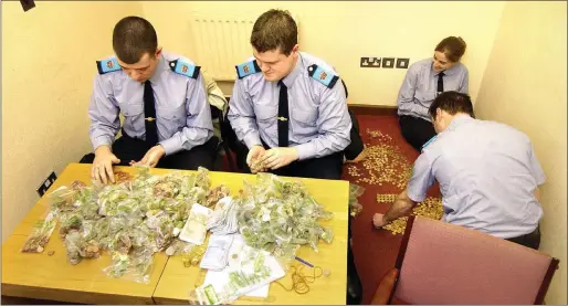  ??  ?? Gardai at Drogheda Garda Station counting money which was collected for the tsunami aid appeal in 2005