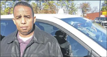  ?? MATT KEMPNER / AJC ?? Mohamed Hussein, an Atlanta taxi driver who has an economics degree, said he sees his investment­s in the business being decimated by changes in regulation­s.