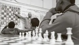  ?? Jon Shapley / Staff photograph­er ?? Andrew Koenigsber­g teaches chess strategies after school at Saint Peter the Apostle Catholic School in May 2019. The Houston campus has not been closed.