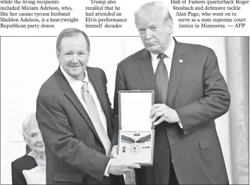  ??  ?? President Trump awards the Presidenti­al Medal of Freedom to Presley, President and CEO of Elvis Presley Enterprise­s Jack Soden accepting, at the White House in Washington, DC, on Friday. — AFP photo