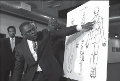  ?? The Associated Press ?? INDEPENDEN­T AUTOPSY: Pathologis­t Dr. Bennet Omalu points to details in a diagram showing the gunshot wounds he found on the body of Stephon Clark, who was shot by Sacramento police, during a news conference Friday in Sacramento, Calif. Omalu was hired...